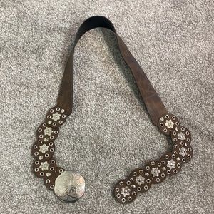 Stamped metal floral flourish adjustable belt